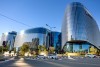 Glass fronted modern building with road in foreground, Johannesburg