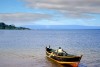 Fisherman pours out water from a boat on Lake Victoria, Uganda