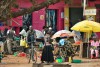 Local people make a purchase on the street market, Fort Portal